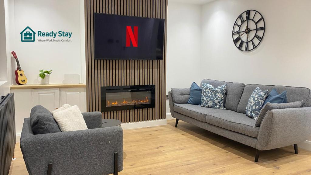 a living room with two couches and a fireplace at Ready Stay Work Lodge in Birmingham