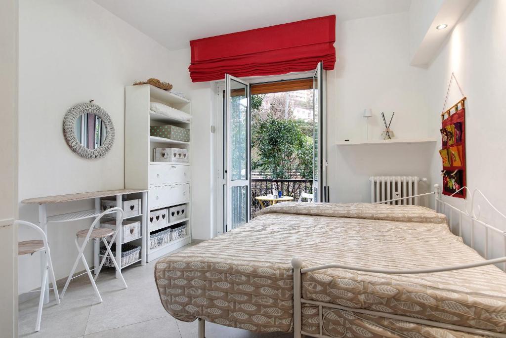 a bedroom with a bed and a red curtain at Margherita - Fronte Mare in Rapallo