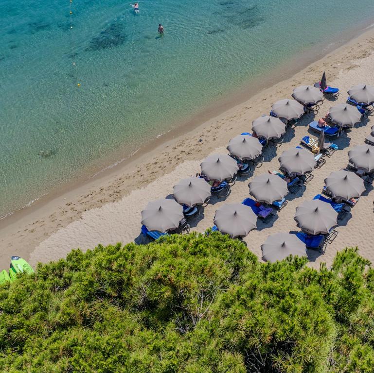 an overhead view of a beach with umbrellas and the ocean at Skiathos Thalassa Cape Hotel, Philian Hotels and Resorts in Megali Ammos