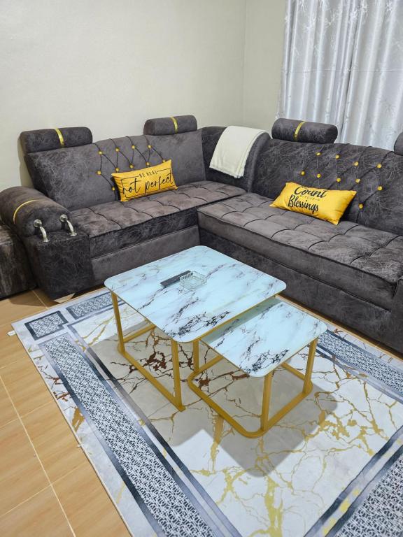 a living room with a couch and two tables at Tulivu 2 stays in Nyahururu