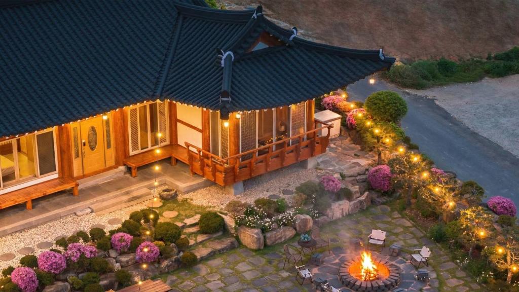 an overhead view of a house with a garden and lights at Yeosu Elon Pension in Yeosu