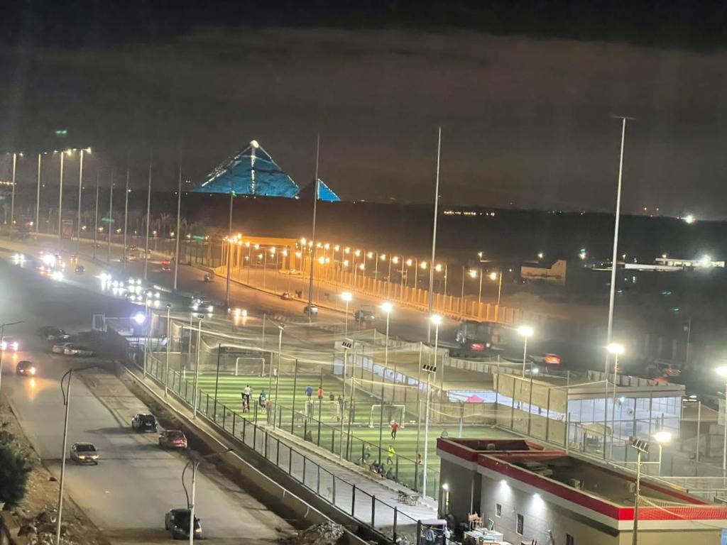 a city lit up at night with street lights at Cloud pyramids view inn in ‘Ezbet `Abd el-Ḥamîd
