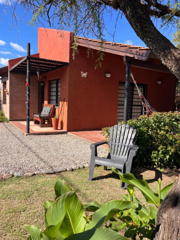 a white chair sitting in front of a house at Cabañas Quinco in Merlo