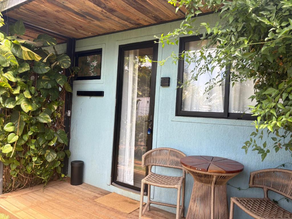a patio with a table and chairs on a porch at Oby Noronha in Fernando de Noronha