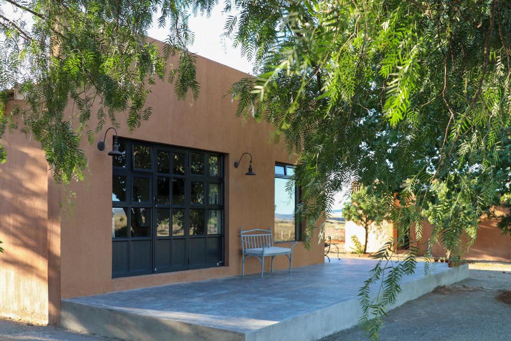 a bench sitting in front of a building at Rietfontein 1888 in De Aar