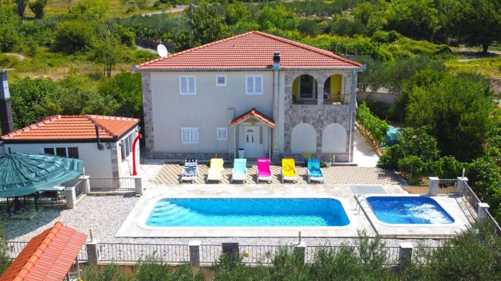 an aerial view of a house with a swimming pool at Vila Nova with private heating pool and jacuzzi in Zavojane