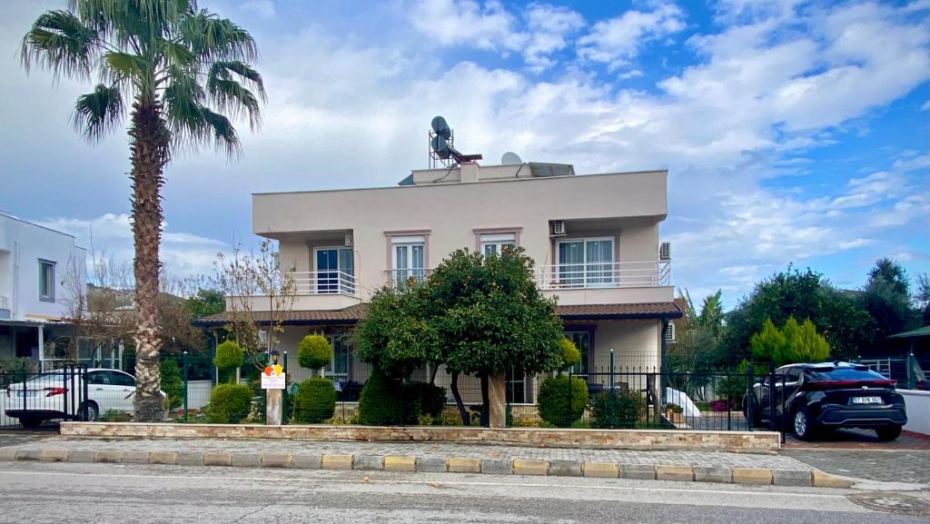 a white building with a statue on top of it at Orange&Lemon Villas Çamyuva in Kemer