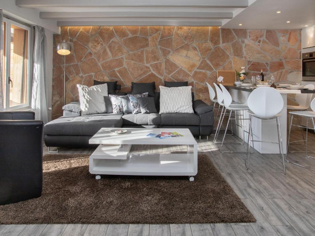 a living room with a couch and a table at Apartment Stem 2 by Interhome in Verbier