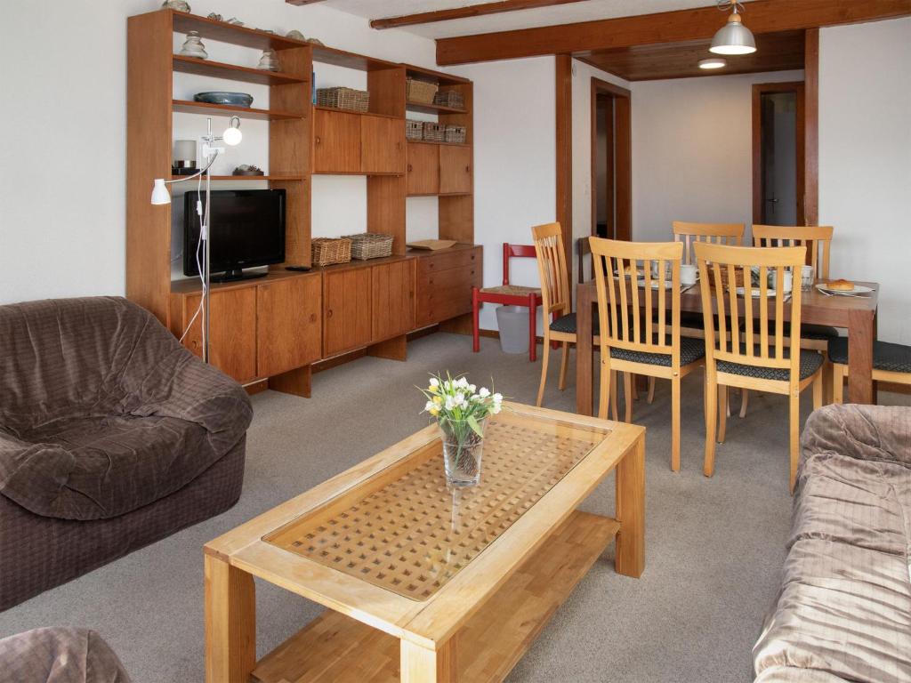 a living room with a couch and a table at Apartment Porthos 37 by Interhome in Verbier
