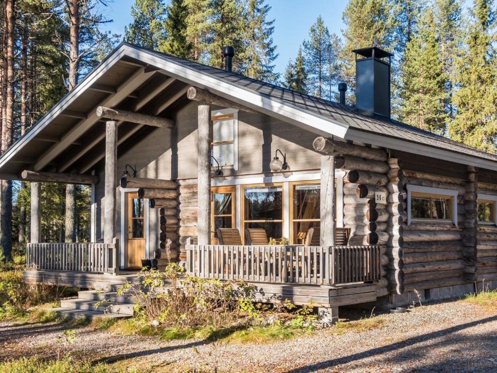a log cabin in the woods with a porch at Holiday Home Putilanranta by Interhome in Saapunki