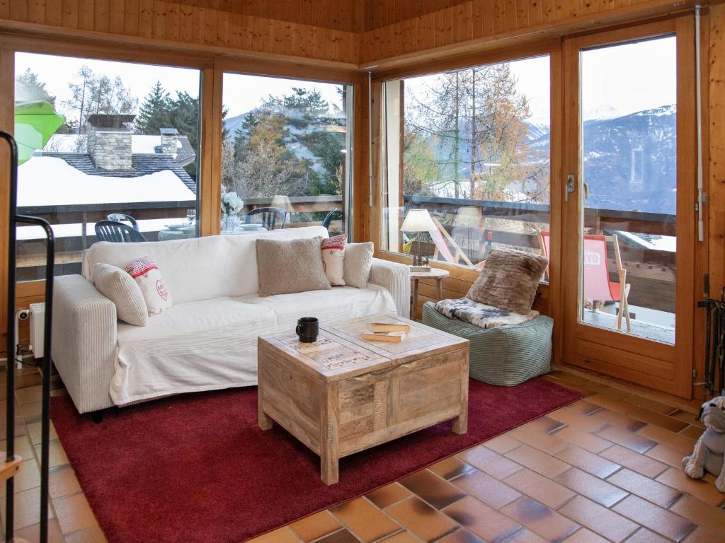 a living room with a couch and a coffee table at Apartment Beau Site No 21 by Interhome in Ovronnaz