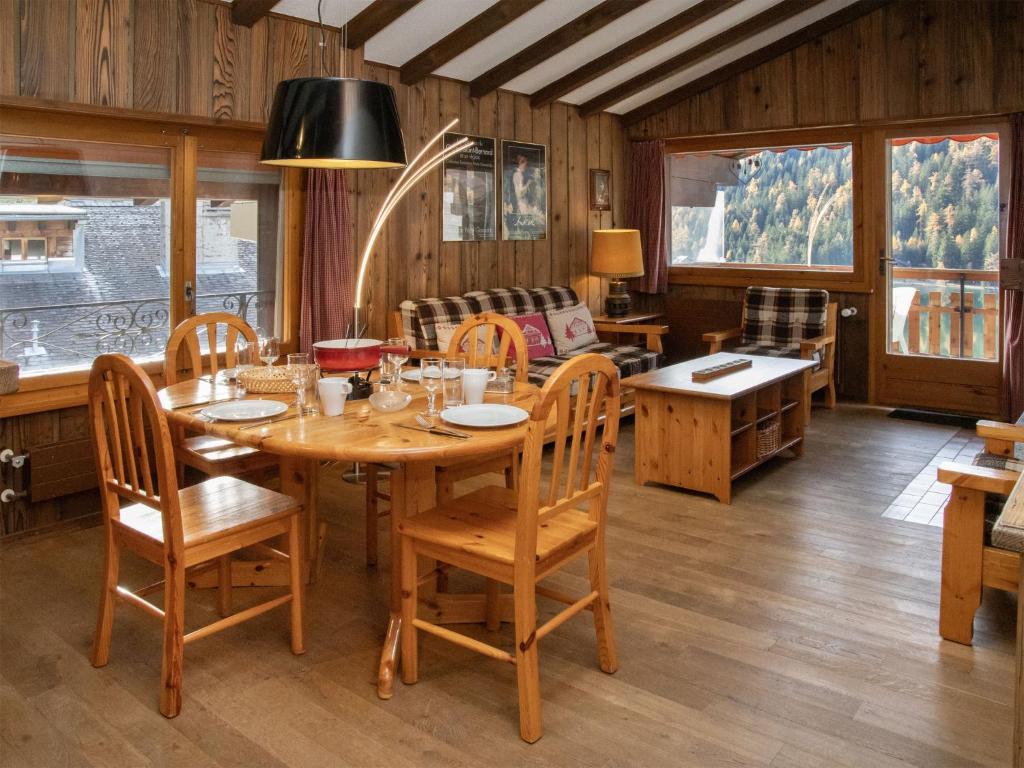 a dining room with a wooden table and chairs at Apartment Parc B 431 by Interhome in Champex