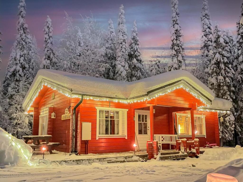 a cabin in the snow with snow covered trees at Holiday Home Joutilas by Interhome in Ruka