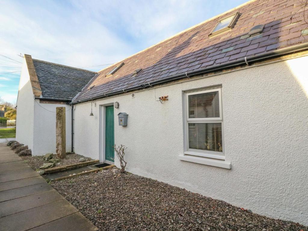 a white house with a window and a roof at 78 Findhorn in Forres