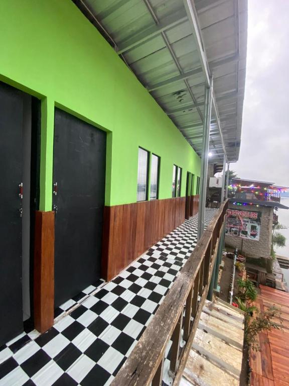 a building with a checkered floor and green at WD adventure Pangalengan in Palayangan
