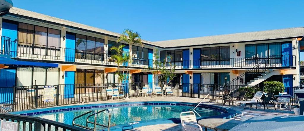 a hotel with a swimming pool in front of a building at Oceans Beach Resort 735 in Deerfield Beach