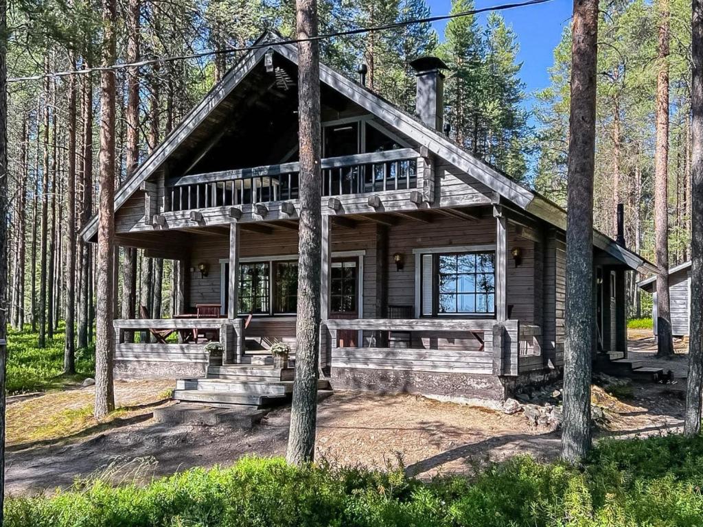 a log cabin in the woods with a deck at Holiday Home Kitkaranta by Interhome in Kitka