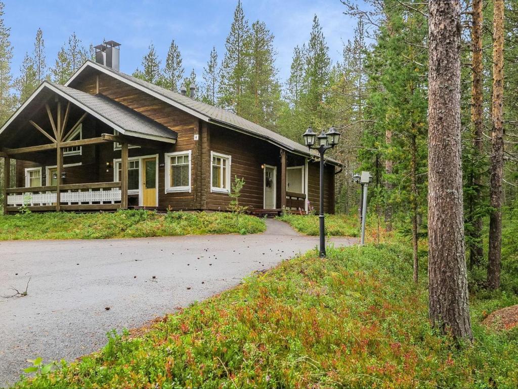 a log cabin in the middle of a forest at Holiday Home Artturi by Interhome in Levi