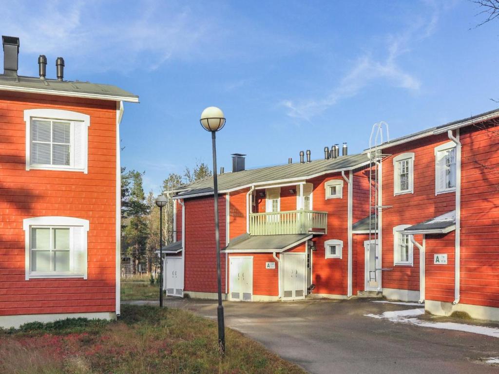 a row of orange brick buildings with a street light at Holiday Home Moitakuru a5 by Interhome in Saariselka