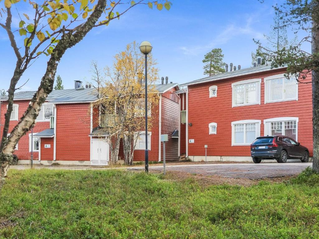 a car parked in front of a red house at Holiday Home Moitakuru a14 by Interhome in Saariselka