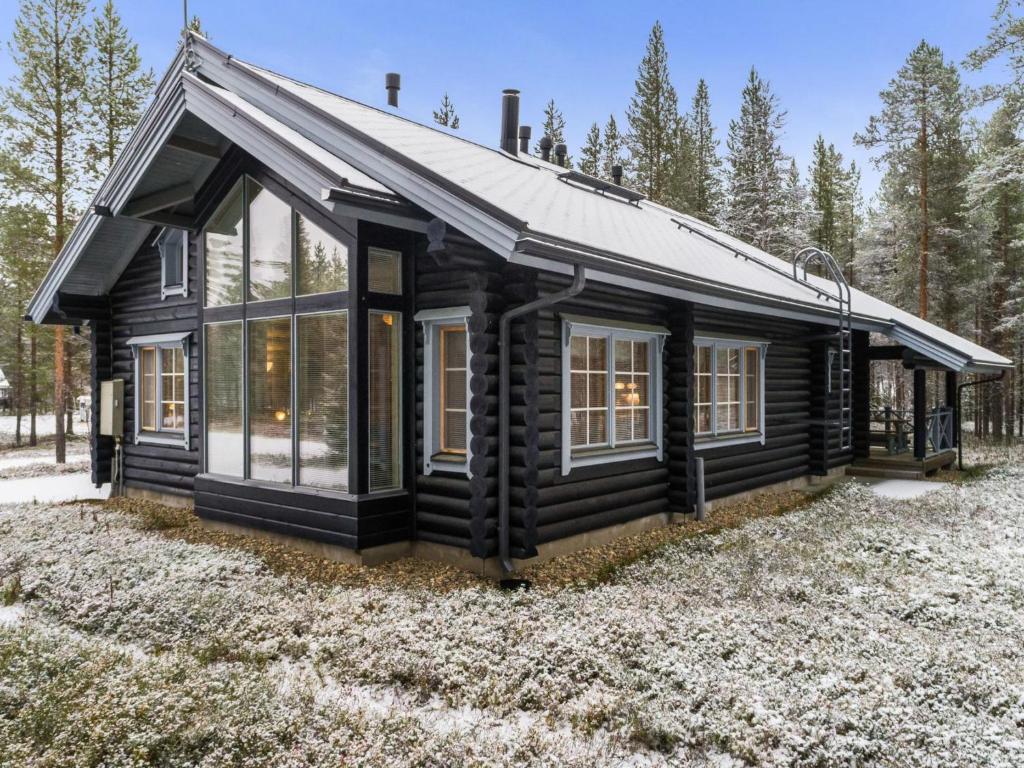 a log cabin with windows and a roof at Holiday Home Aspilevi by Interhome in Levi