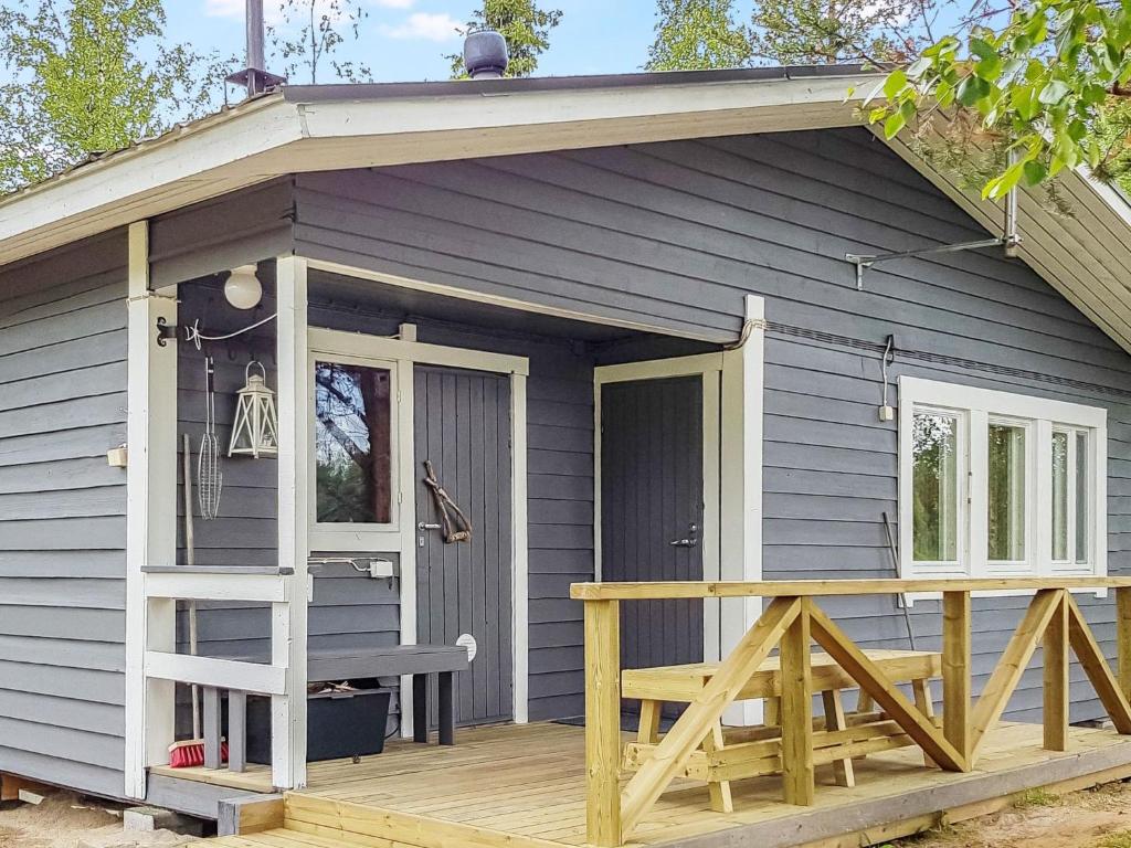 a small house with a porch and a deck at Holiday Home Mukan maja by Interhome in Köngäs