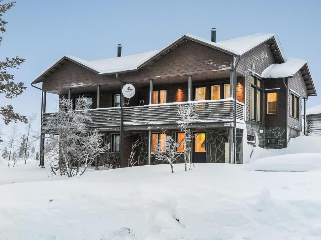 a house covered in snow in front at Holiday Home Karhu a by Interhome in Saariselka