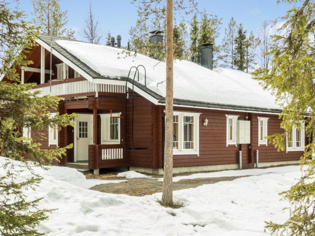 a log cabin in the woods in the snow at Holiday Home Hirvas levi 2 by Interhome in Levi