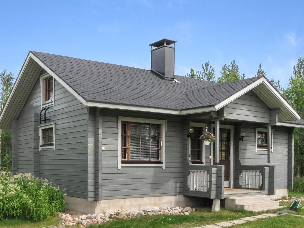 a gray house with a black roof at Holiday Home Ahonlaita by Interhome in Karvonen