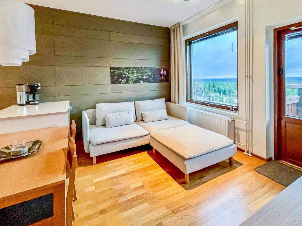 a living room with a couch and a table at Holiday Home Ski chalets 6203 by Interhome in Ylläs