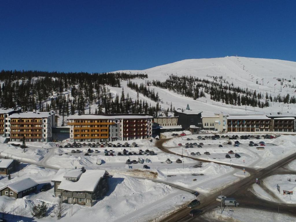 a resort in the snow with a mountain in the background at Holiday Home Ylläs chalets a502 by Interhome in Ylläs