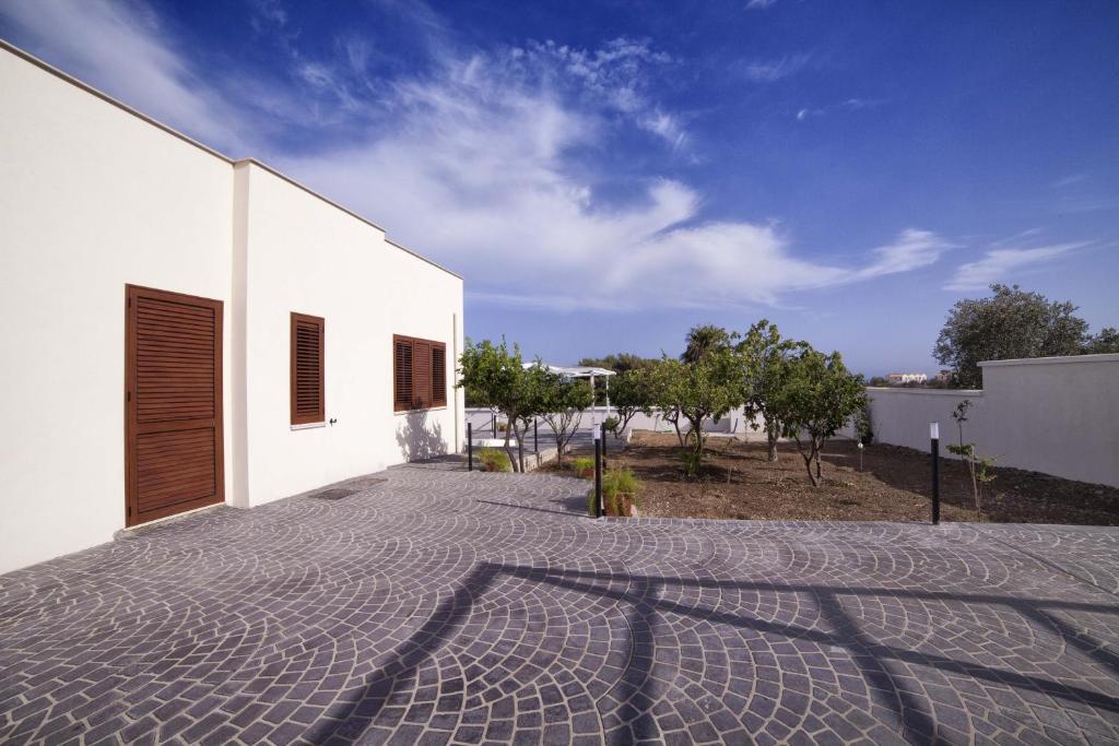 a courtyard of a white building with a sky at Home Scala dei Turchi B&B in Realmonte