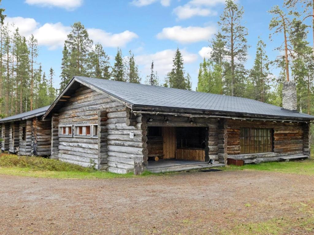 a log cabin with a black roof at Holiday Home Metsä-luosto by Interhome in Luosto