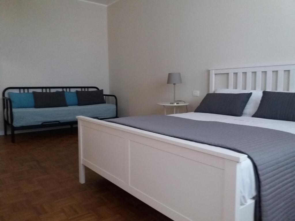 a bedroom with two beds and a couch at Home Scala dei Turchi B&B in Realmonte