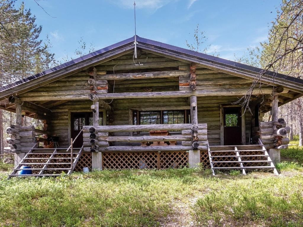 an old log cabin with a large porch and a porch at Holiday Home Kulpakko 3 by Interhome in Tiainen
