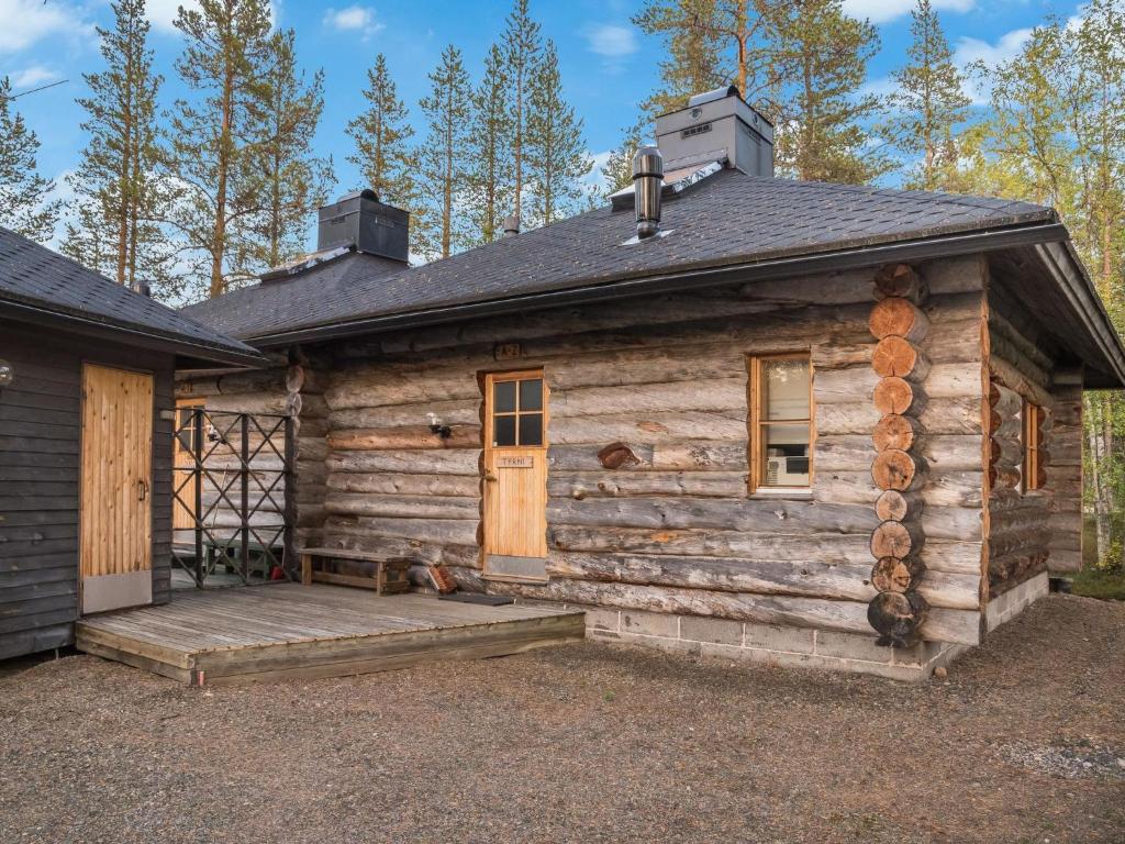 a log cabin with a porch and a door at Holiday Home Ylläsparit as- 2 by Interhome in Ylläsjärvi
