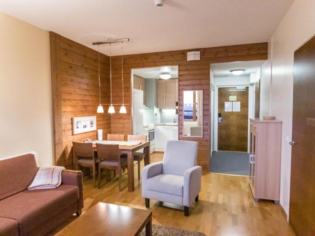 a living room with a couch and a dining room at Holiday Home Ylläs chalets a202 by Interhome in Ylläs