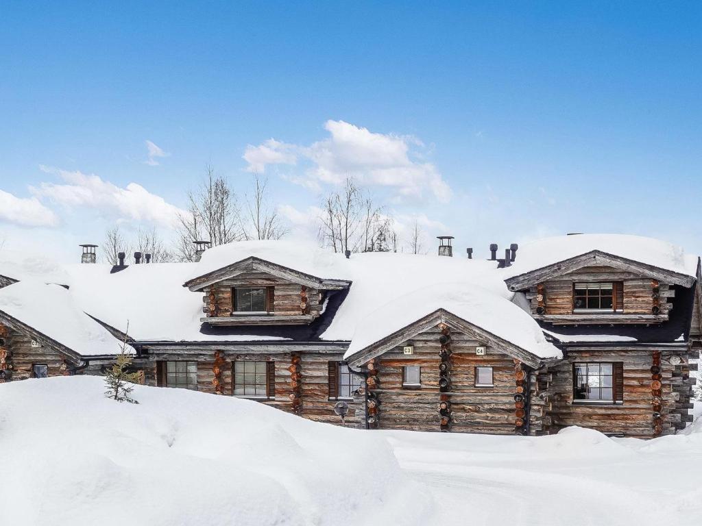 a log house covered in snow at Holiday Home Kantapää c 3 by Interhome in Luosto