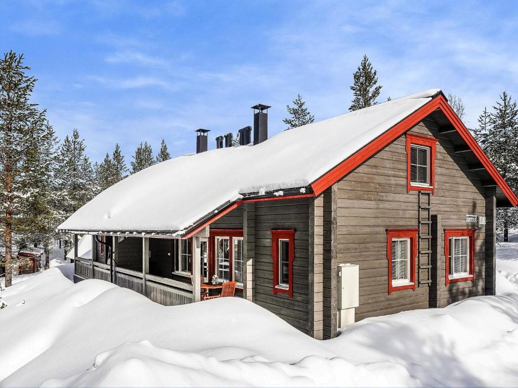 a small house with a snow covered roof in the snow at Holiday Home Lustola a by Interhome in Luosto