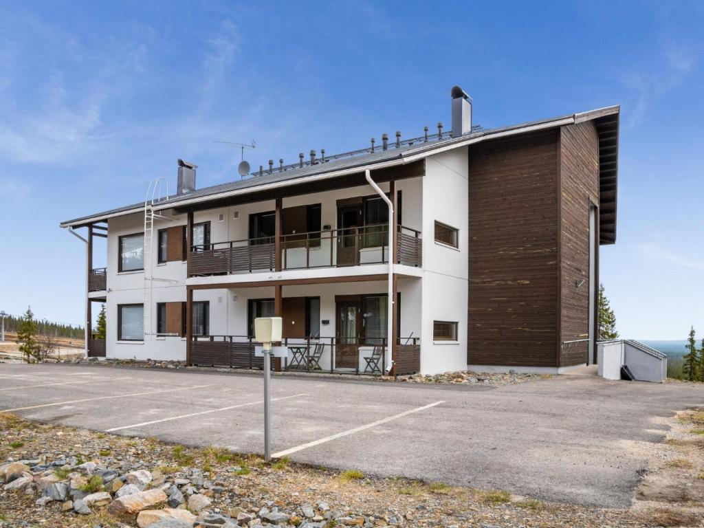 a building with a parking lot in front of it at Holiday Home Villa ylläs 201 by Interhome in Ylläs