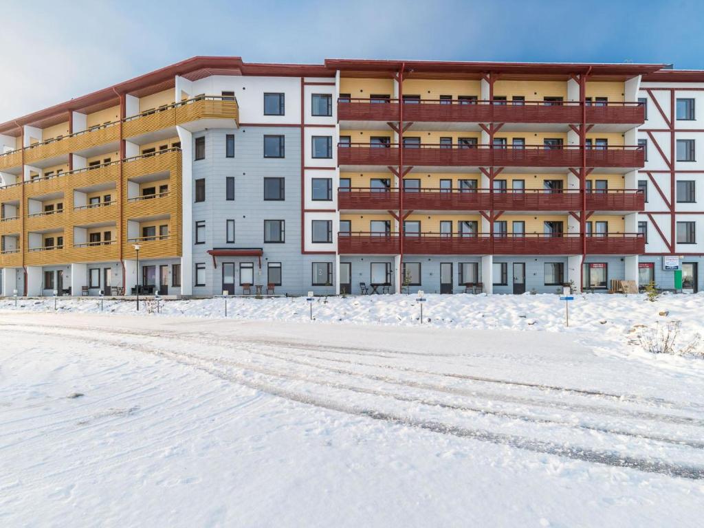 a building in the snow with a snow covered street at Holiday Home Ylläs chalets 2405 by Interhome in Ylläs