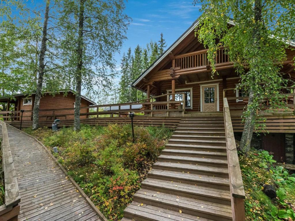 a log cabin with stairs leading to the front door at Holiday Home Koivuranta by Interhome in Jämijärvi