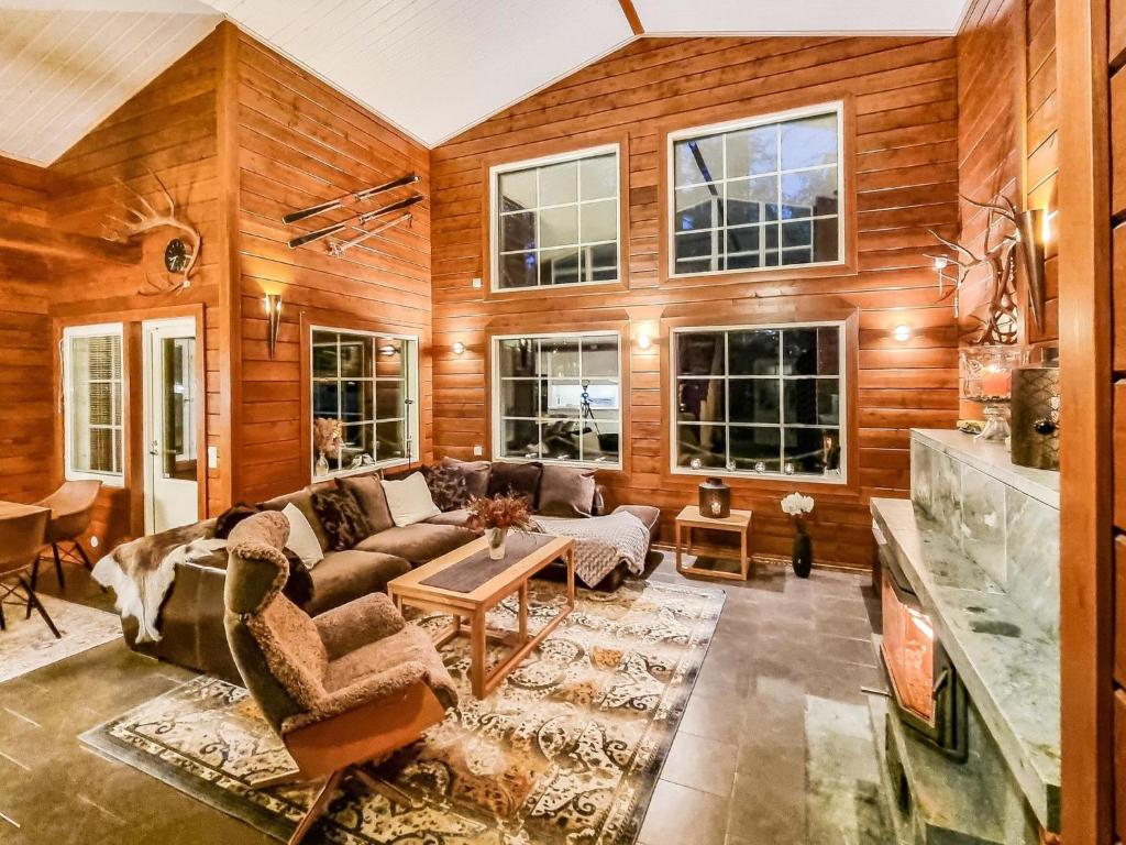 a living room with a couch and a table at Holiday Home Arctic chalet by Interhome in Ylläsjärvi