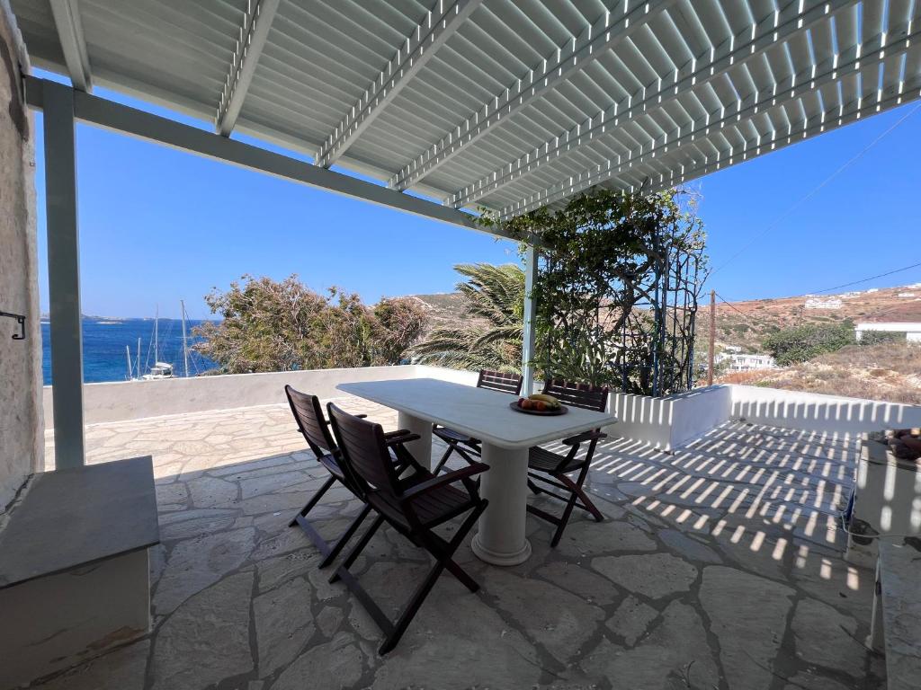 a white table and chairs on a patio at Kimoliatiko in Kimolos