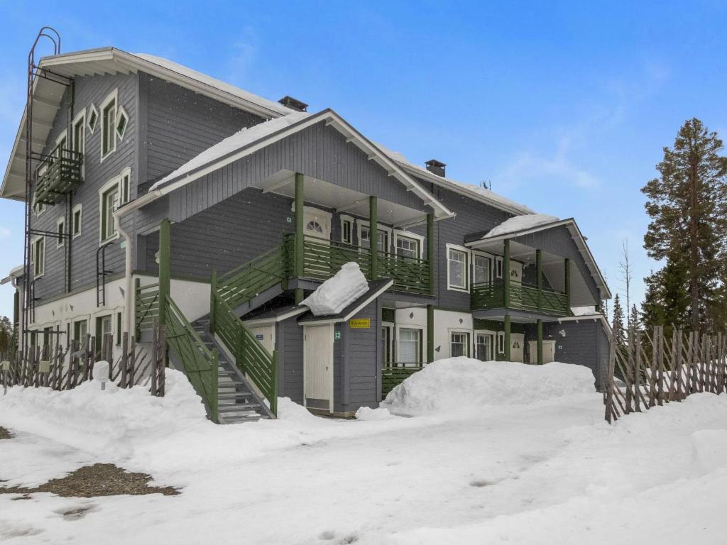 a house with snow on the ground in front of it at Holiday Home Ylläs-eeli green house c2 by Interhome in Ylläsjärvi