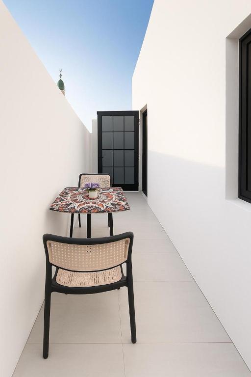 a table and a chair in a room at Sunshine Flat in Al Khobar