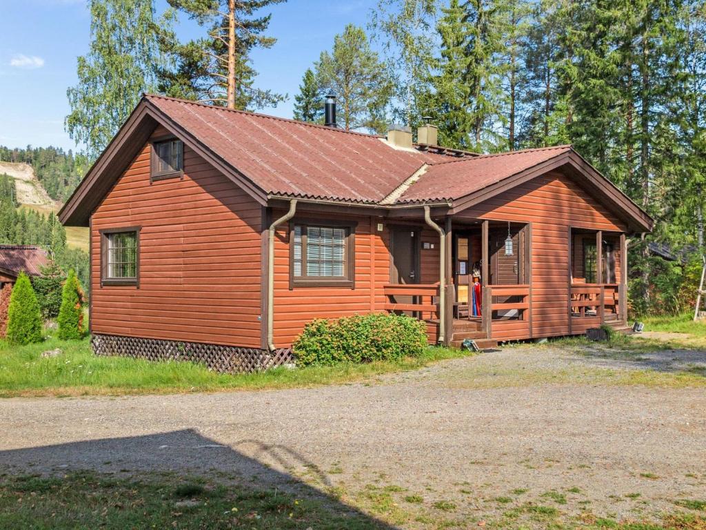 a log cabin with a brown roof at Holiday Home Villa illi by Interhome in Tahkovuori