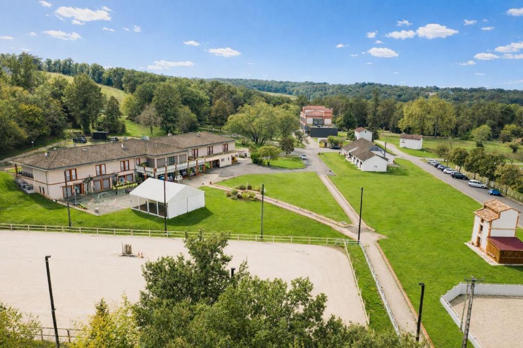 an aerial view of a building with a park at Domaine de Pousiniès in Saint-Étienne-de-Tulmont