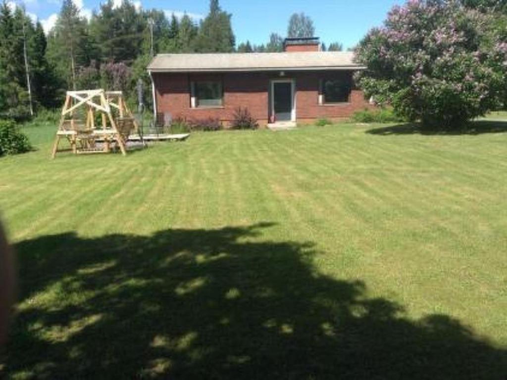 a large yard with a house and a playground at Holiday Home Jokela by Interhome in Horonkylä