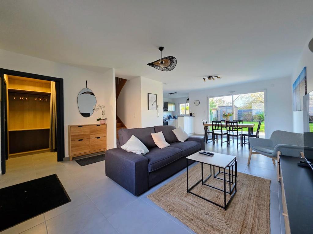a living room with a couch and a table at Tiboulen - Ste Luce sur Loire in Sainte-Luce-sur-Loire